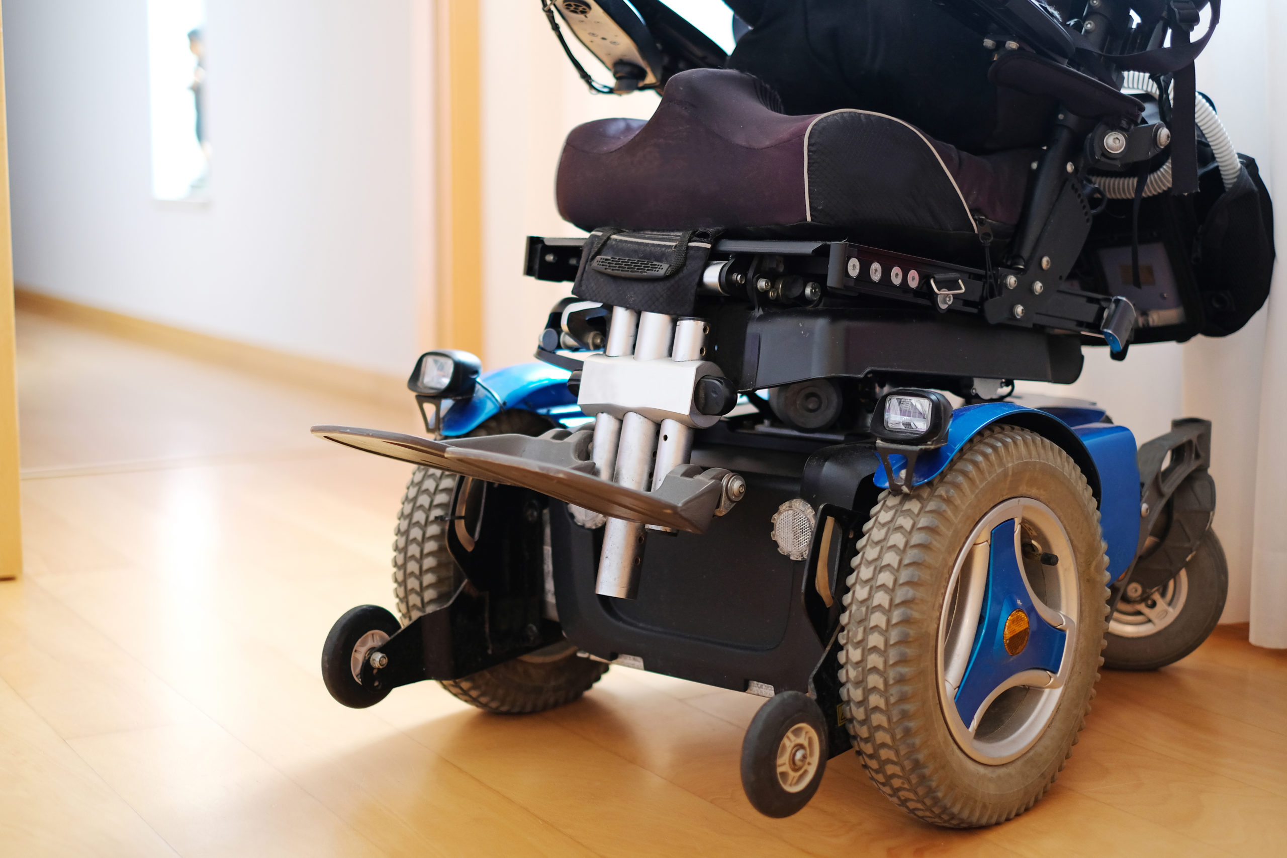 Blue electric wheelchair for disabled people - indoors